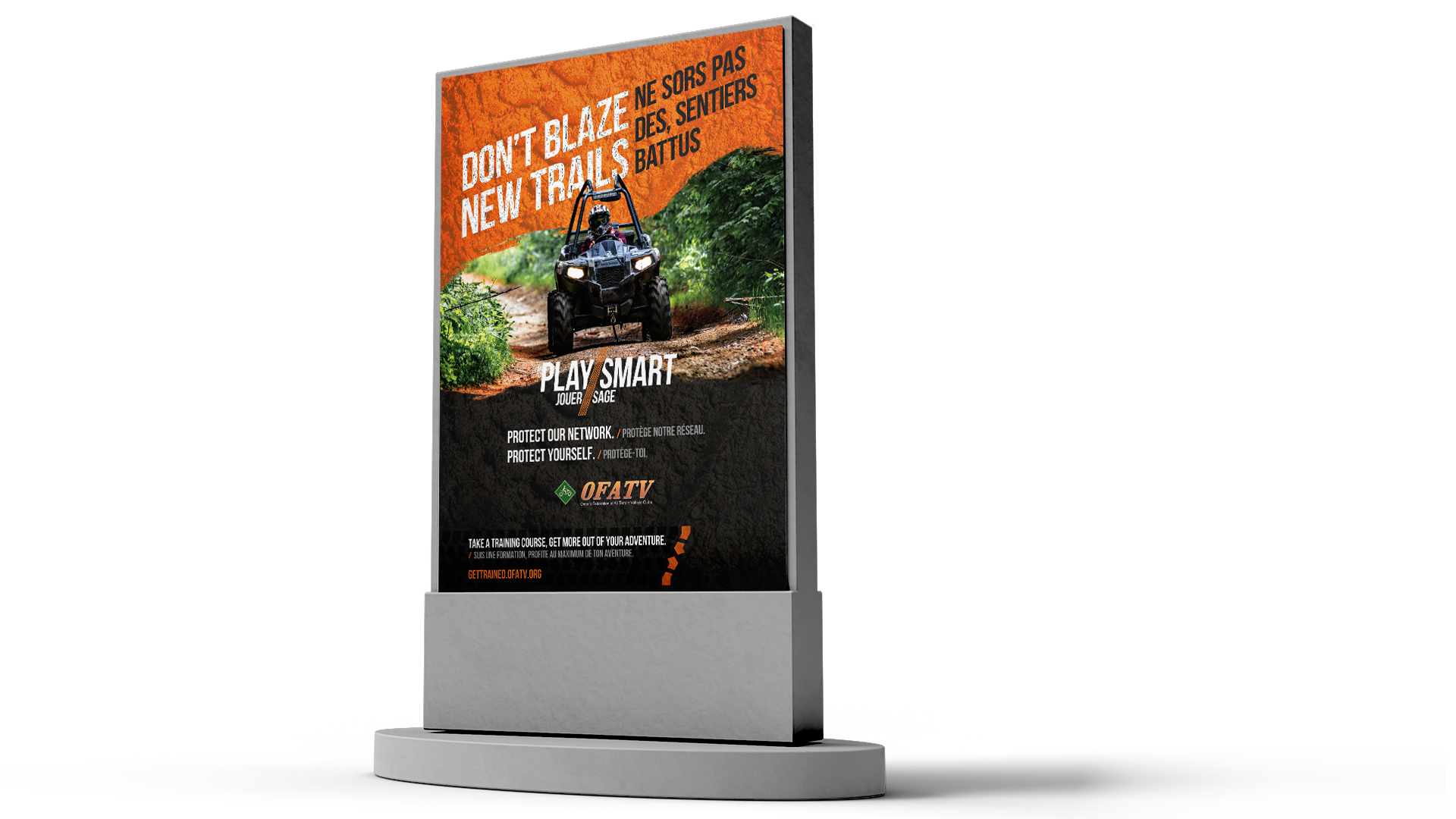 Outdoor kiosk on white background showing ATV safety ad with message: ‘Don’t blaze new trails / Ne sois pas des sentiers battus.’