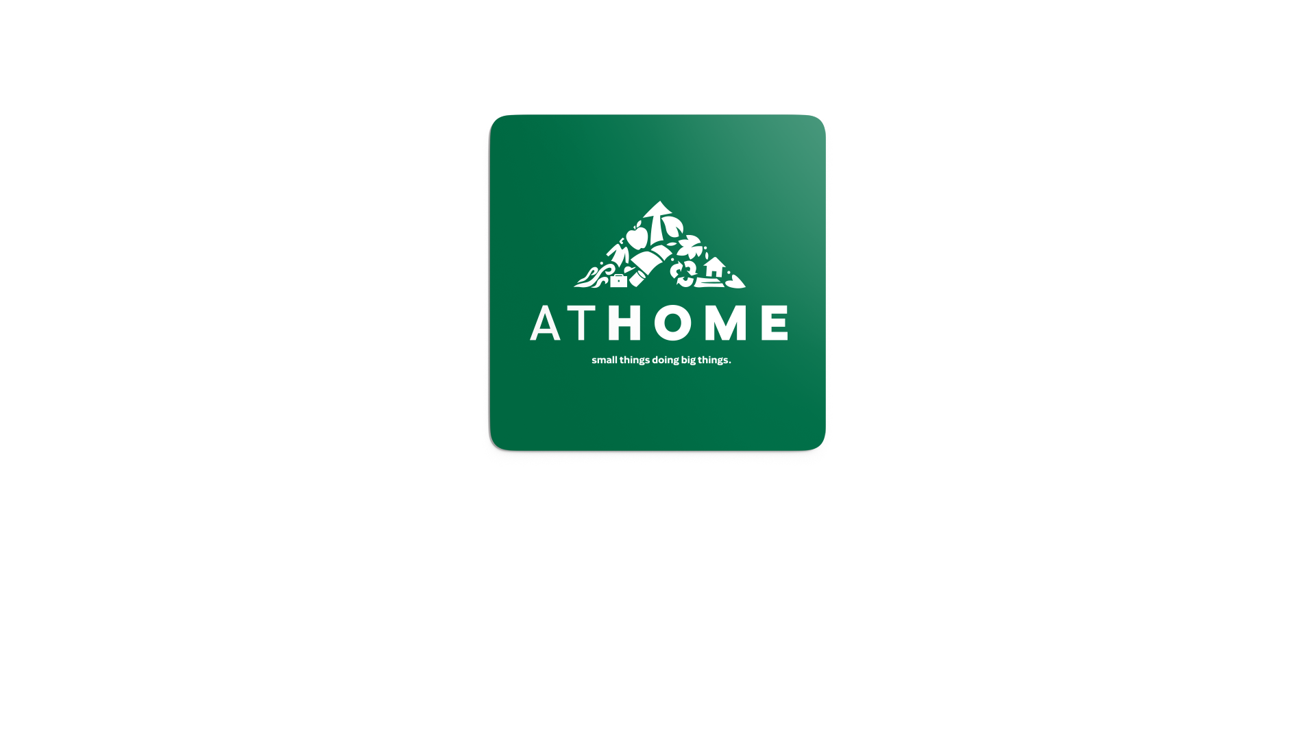 At Home logo in white on a square, dark green sticker with rounded corners.