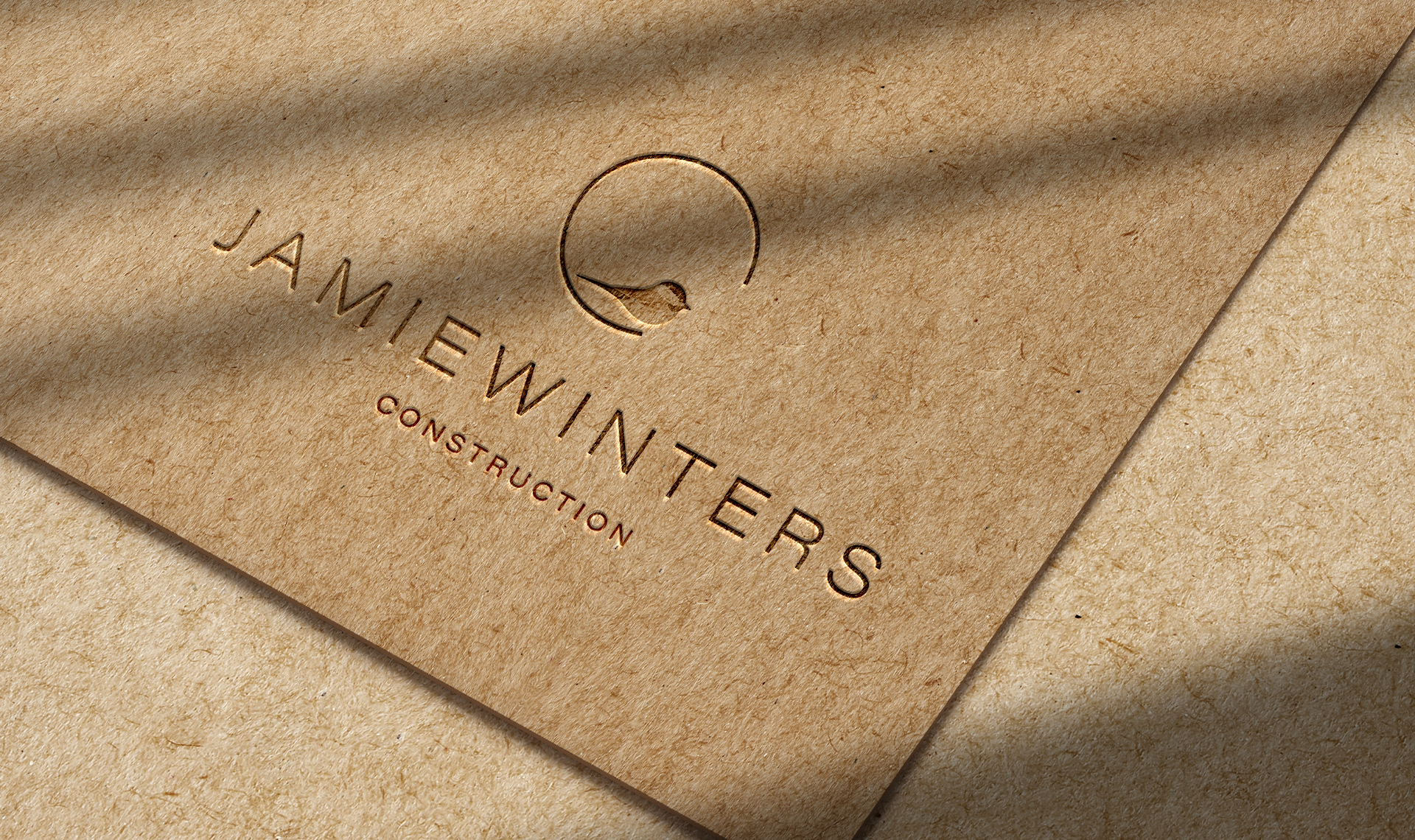 Jamie Winters Construction logo carved or etched into wood.