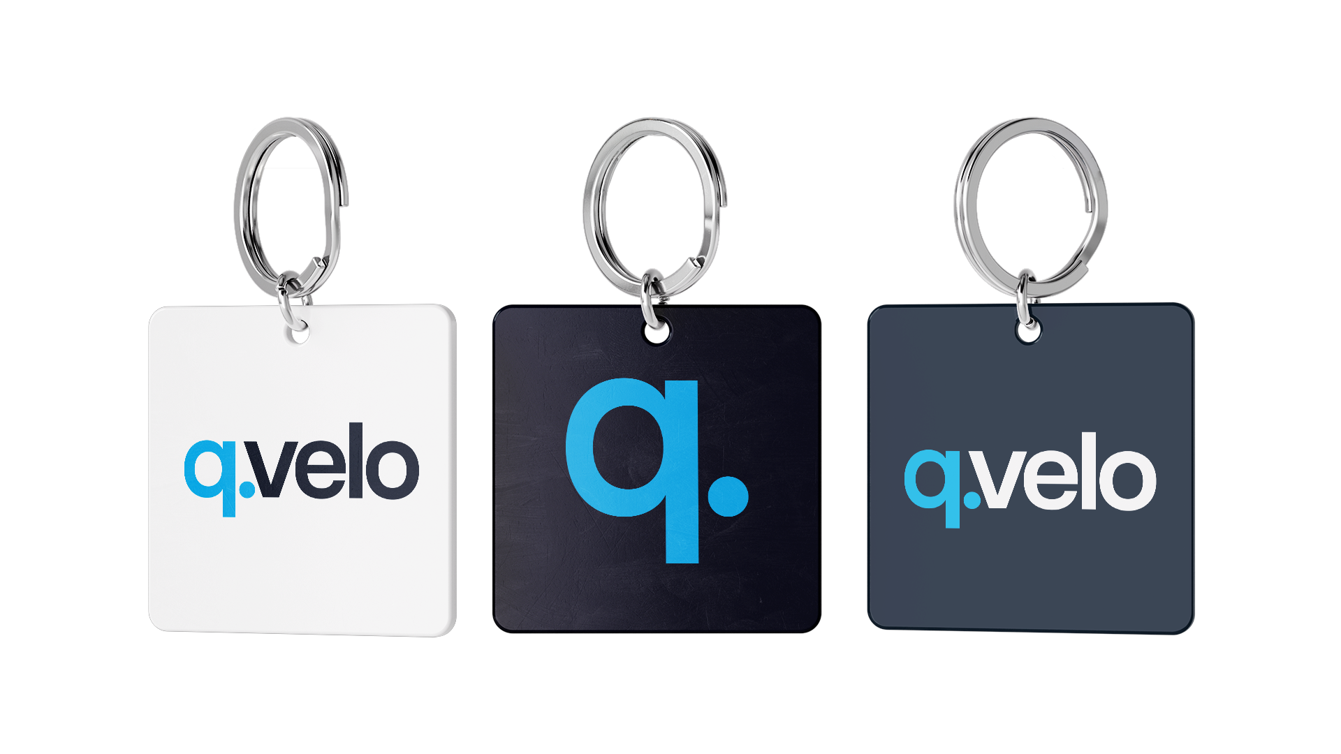 Three square keychains: 1. white with QVelo logo, 2. black with ‘q.’ icon, 3. grey with reversed QVelo logo.
