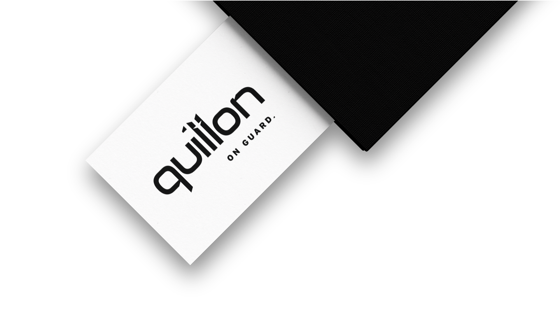 White business card back with Quillon logo centred in black.