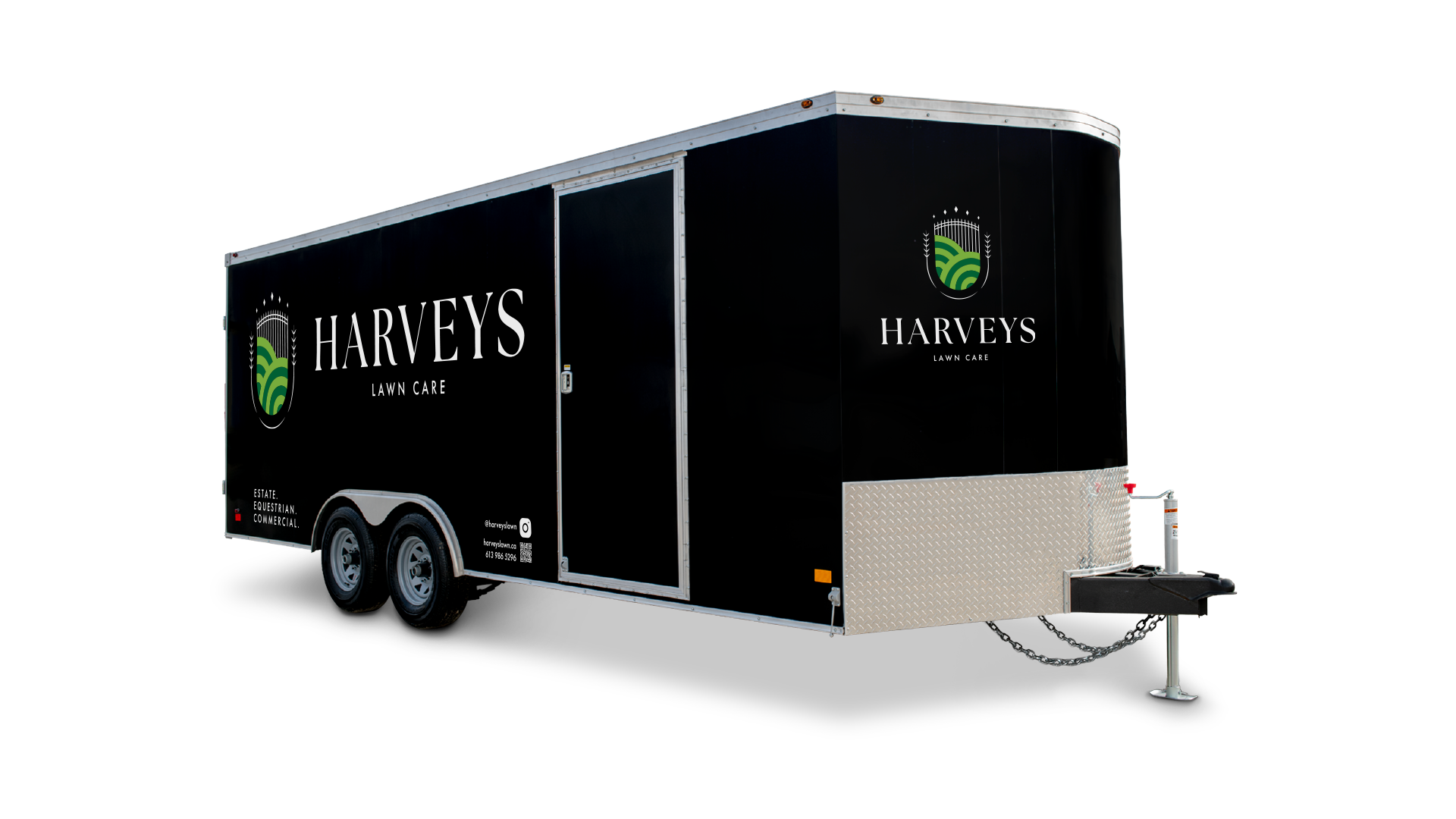 Black enclosed utility trailer with Harvey’s Lawn Care logo, tagline and contact information.
