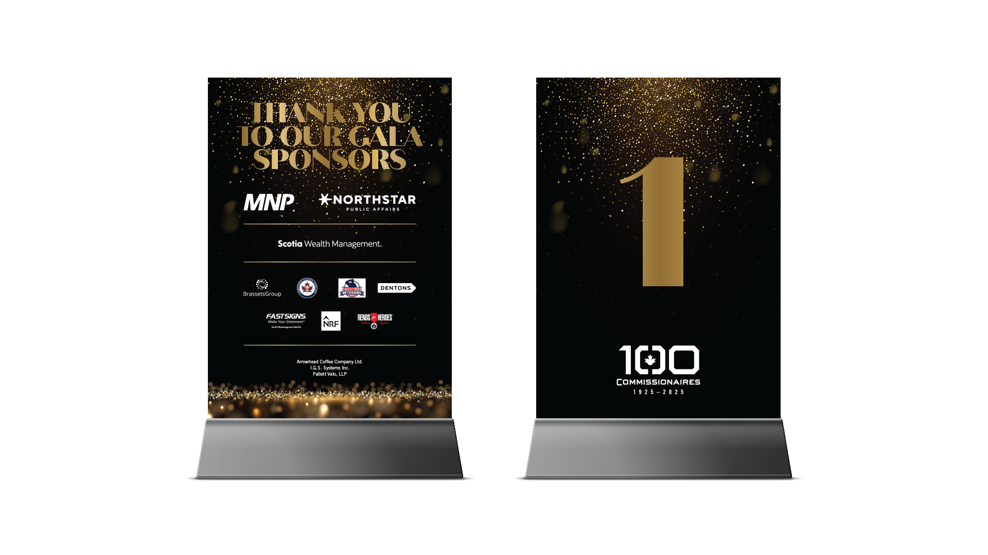 Table cards with black and gold centennial gala branding, numbered on one side and sponsor logos on the other, displayed in clear acrylic bases.